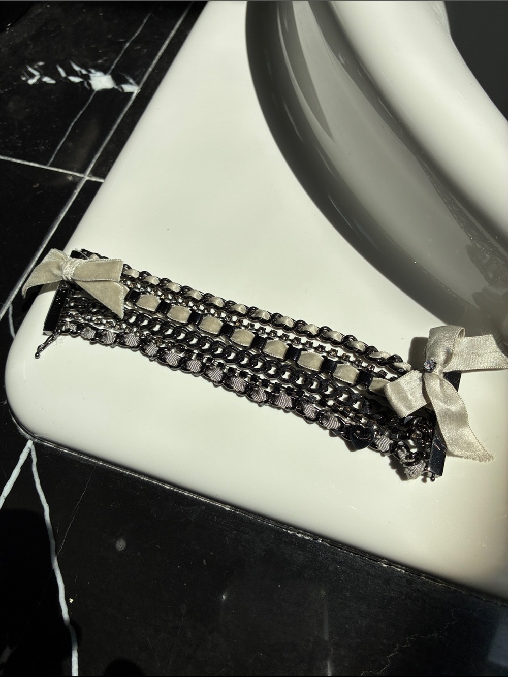 Juicy couture 
Layered Black Chain Bracelet with Cream Satin Bows